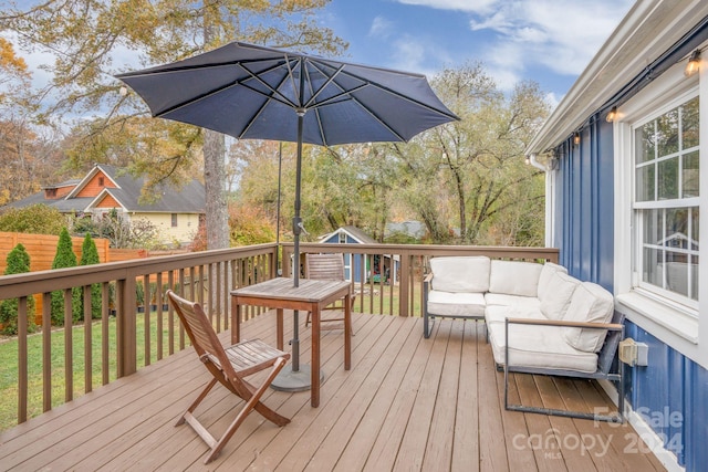 deck with a yard and an outdoor living space