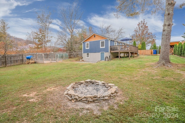 back of house featuring a yard and a deck