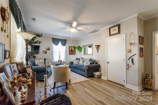 living room featuring light hardwood / wood-style floors, ornamental molding, and ceiling fan