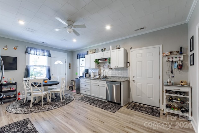 kitchen featuring white cabinetry, light hardwood / wood-style flooring, dishwasher, and crown molding