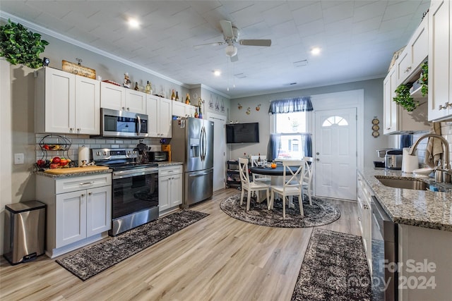 kitchen featuring sink, appliances with stainless steel finishes, and white cabinets