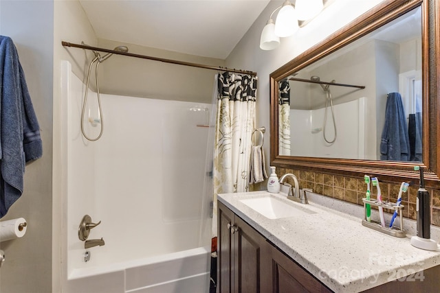 bathroom featuring vanity, shower / tub combo, and backsplash