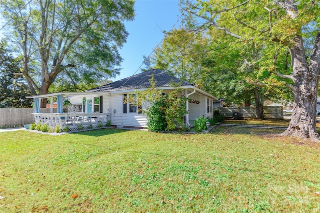 back of property featuring a lawn