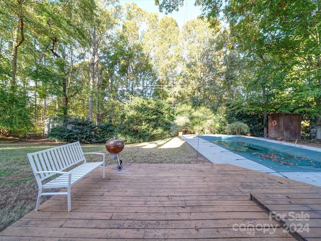 wooden terrace featuring a covered pool