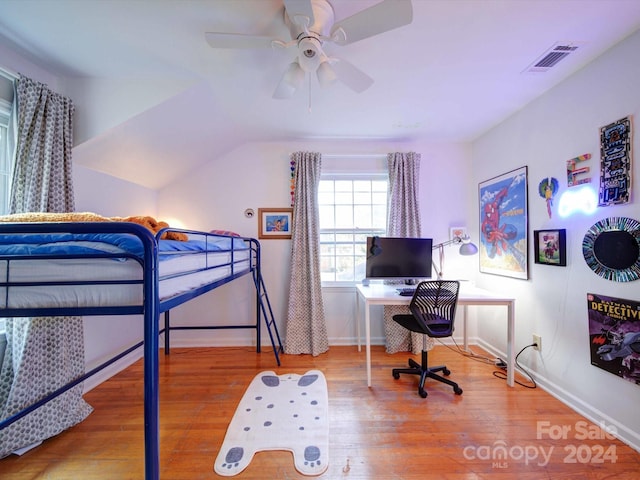 bedroom featuring hardwood / wood-style floors, ceiling fan, and vaulted ceiling