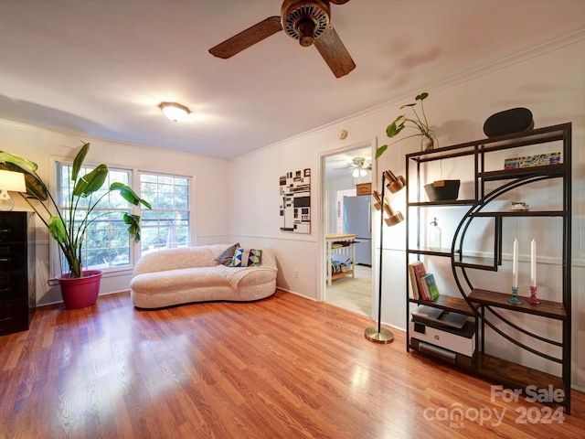 sitting room featuring ceiling fan, hardwood / wood-style floors, and ornamental molding