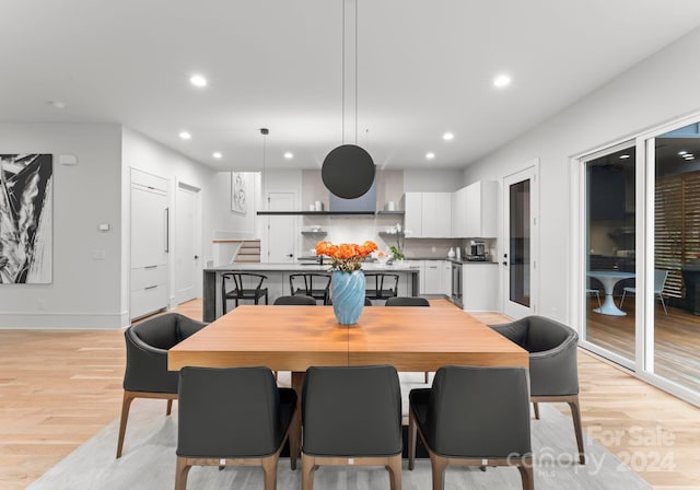 dining space with light hardwood / wood-style flooring