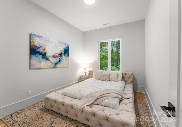 bedroom with hardwood / wood-style flooring