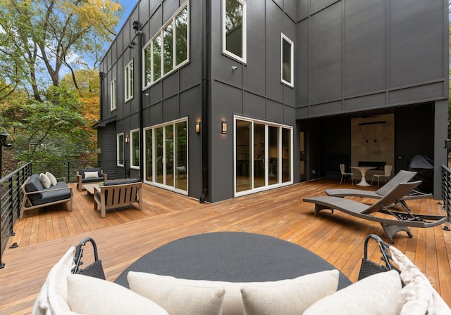 wooden terrace with an outdoor hangout area