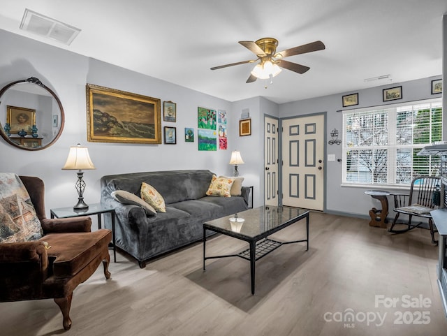 living room with ceiling fan and light wood-type flooring