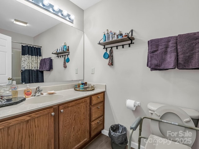 bathroom with a shower with curtain, vanity, and toilet