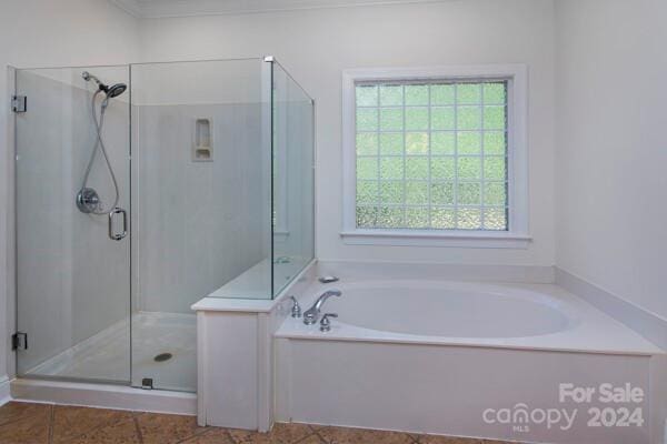 bathroom with tile patterned flooring and shower with separate bathtub