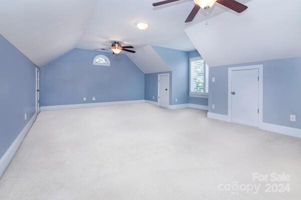 bonus room with light colored carpet, vaulted ceiling, and ceiling fan