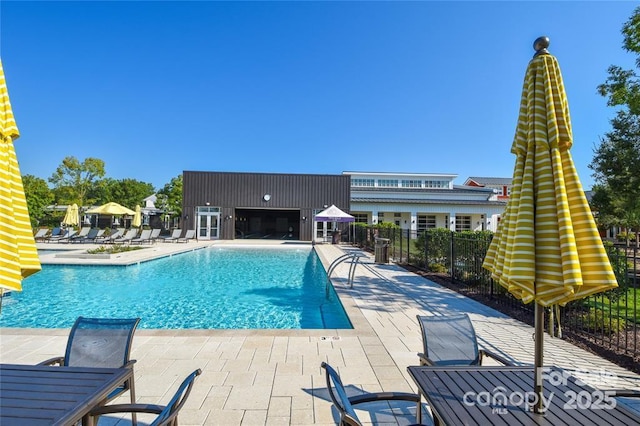 community pool featuring a patio and fence