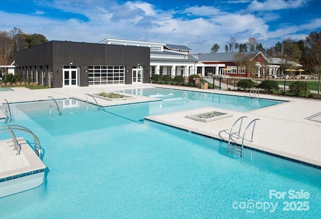 pool with a patio and fence