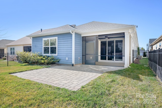 rear view of house featuring a yard, a patio area, and a fenced backyard