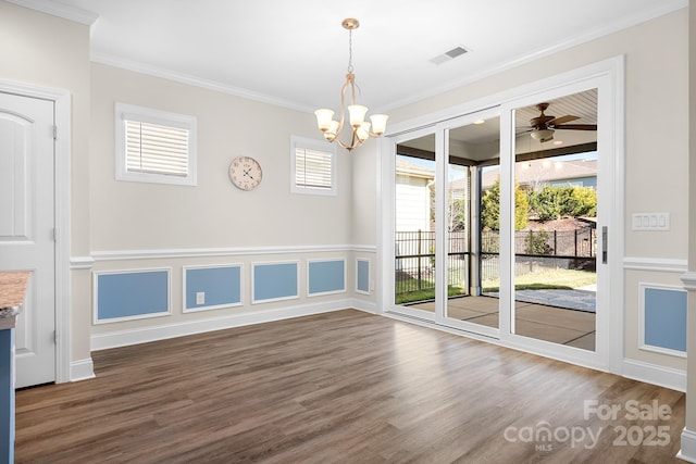 unfurnished room featuring ornamental molding, plenty of natural light, and visible vents