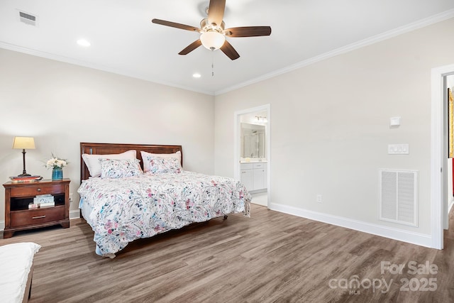 bedroom featuring baseboards, visible vents, wood finished floors, and ornamental molding