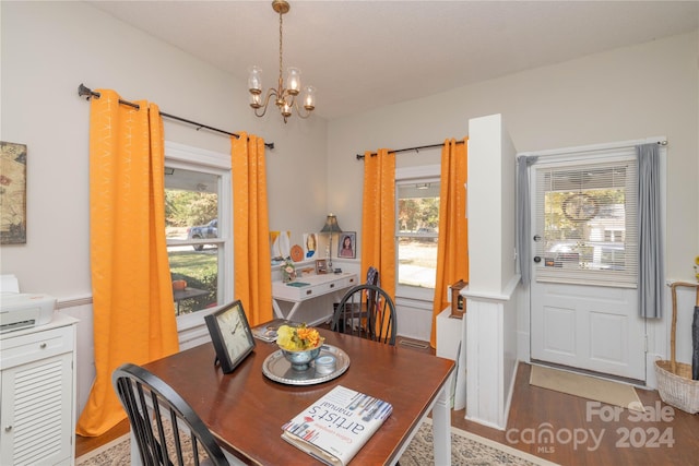 dining area with hardwood / wood-style flooring and a notable chandelier