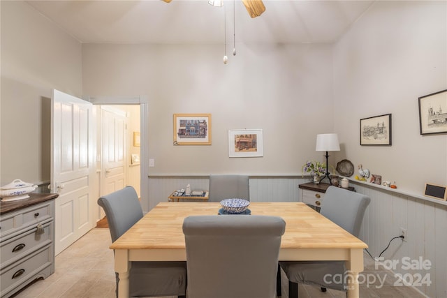 dining space featuring wood walls