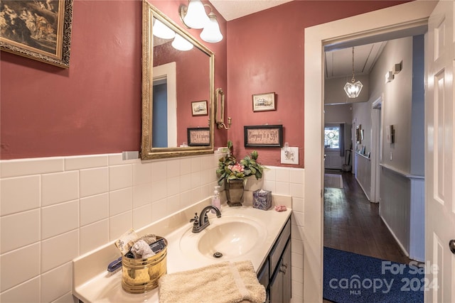 bathroom featuring tile walls, vanity, and wood-type flooring