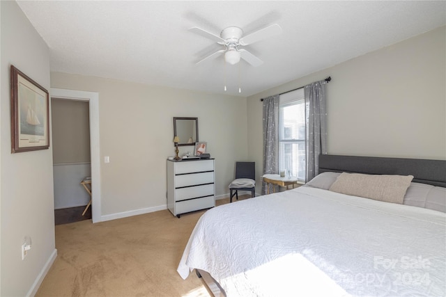 bedroom with ceiling fan and light colored carpet