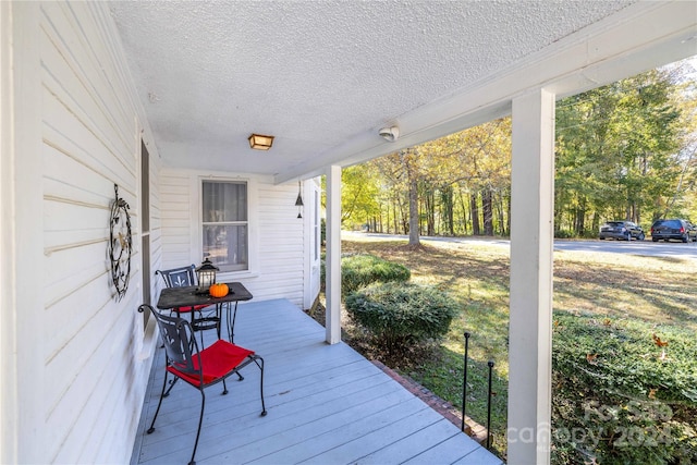 wooden terrace featuring covered porch