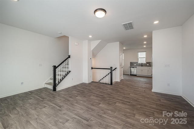 spare room featuring dark wood-style floors, recessed lighting, visible vents, stairway, and baseboards