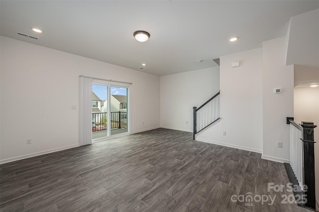 unfurnished living room with recessed lighting, visible vents, baseboards, stairs, and dark wood finished floors