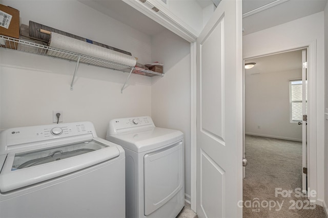 washroom with laundry area, light colored carpet, independent washer and dryer, and baseboards