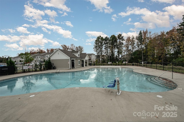 pool featuring fence and a patio