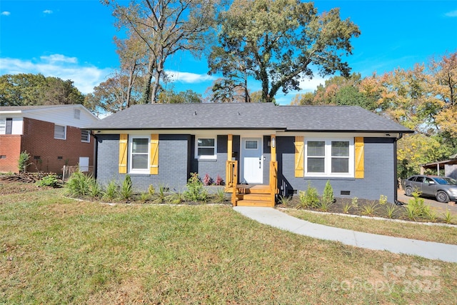 ranch-style home featuring a front yard