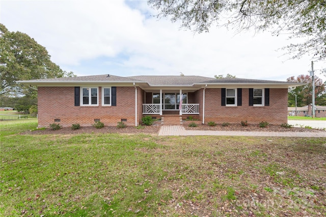 ranch-style home featuring a porch and a front lawn