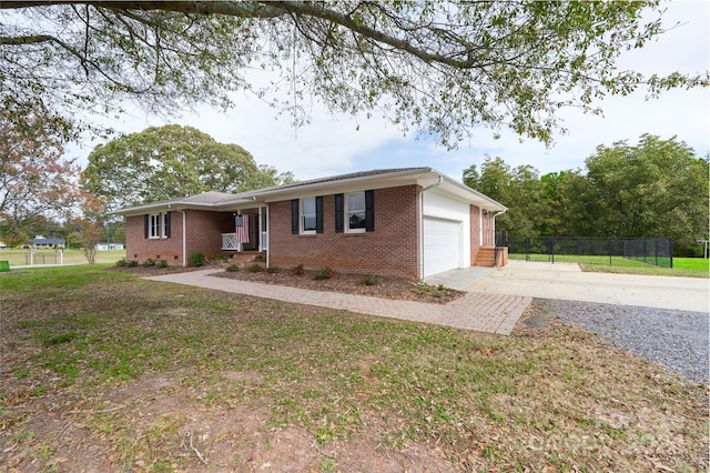 ranch-style home with a front yard and a garage