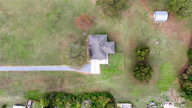 birds eye view of property with a rural view