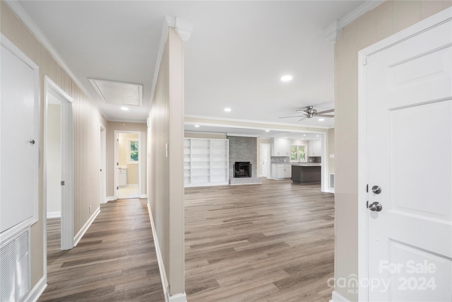 hall with hardwood / wood-style floors and crown molding