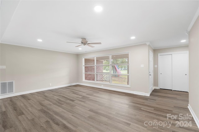 unfurnished living room with ornamental molding, hardwood / wood-style flooring, and ceiling fan