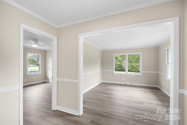 spare room with crown molding, hardwood / wood-style flooring, and ceiling fan