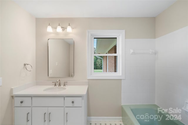 bathroom with vanity and a bathing tub