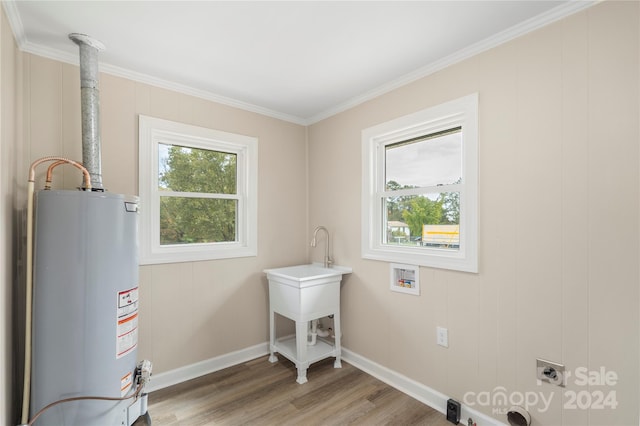 washroom featuring hookup for a washing machine, water heater, hardwood / wood-style flooring, and electric dryer hookup