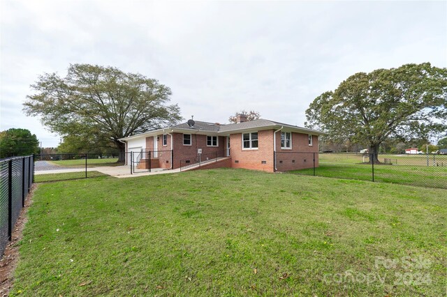 back of house featuring a yard and a patio area