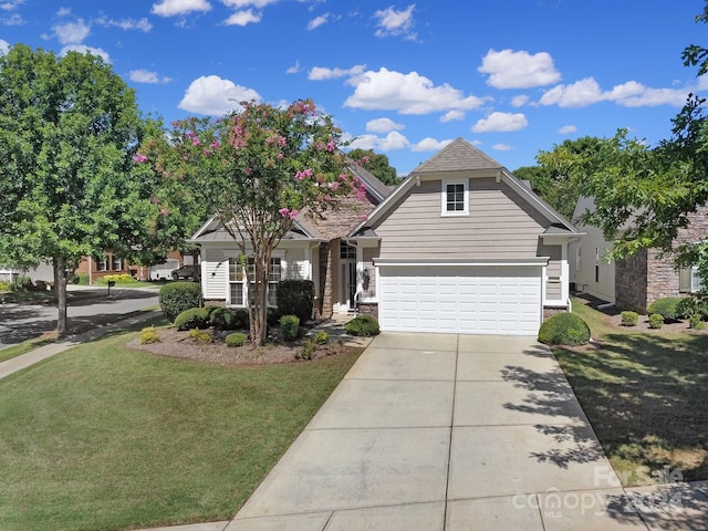 view of front of house featuring a front yard and a garage