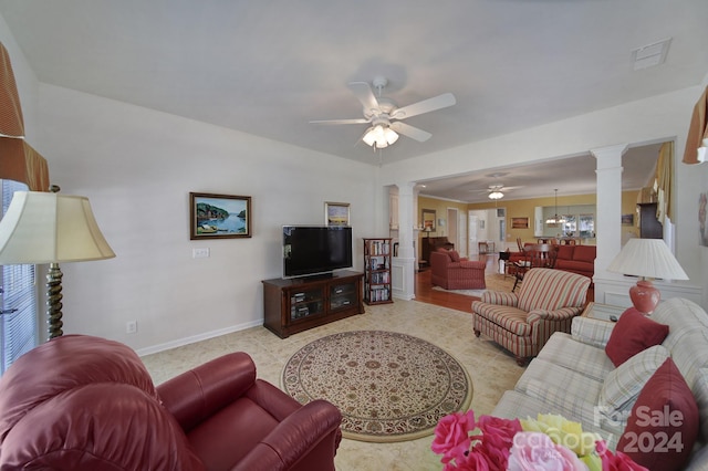 tiled living room featuring ceiling fan with notable chandelier and decorative columns