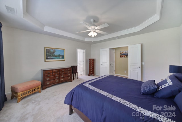 bedroom featuring carpet flooring, ceiling fan, and a raised ceiling