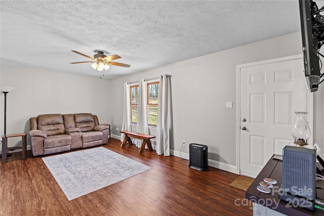 living room featuring a textured ceiling, dark hardwood / wood-style floors, and ceiling fan