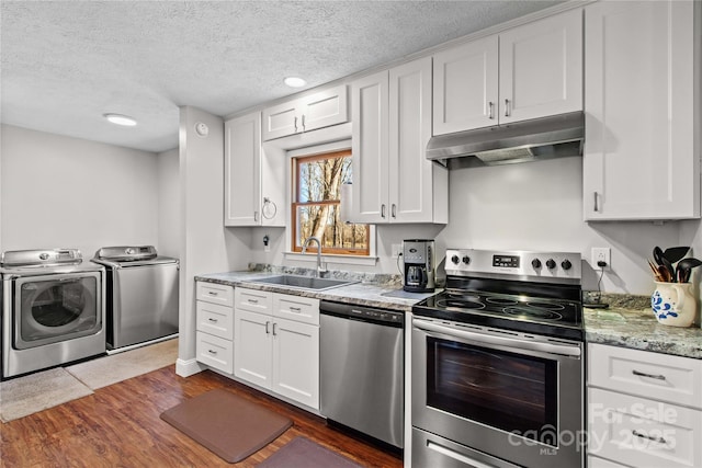 kitchen with white cabinetry, sink, separate washer and dryer, dark hardwood / wood-style floors, and appliances with stainless steel finishes