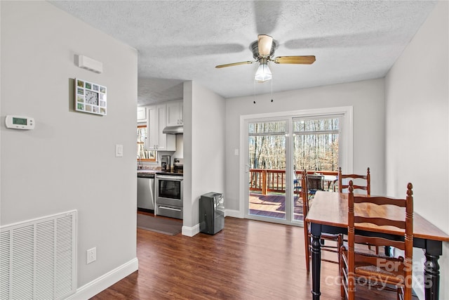 dining space with dark hardwood / wood-style flooring and ceiling fan