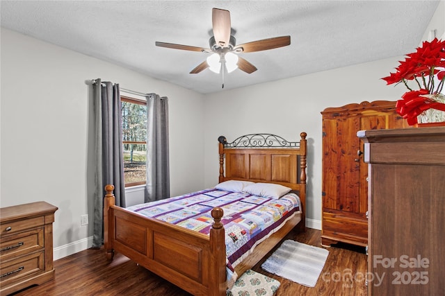 bedroom featuring ceiling fan, dark hardwood / wood-style flooring, and a textured ceiling