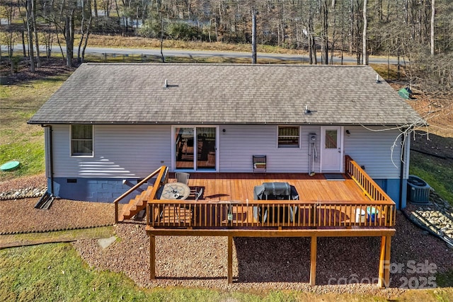 rear view of house featuring a deck and central AC