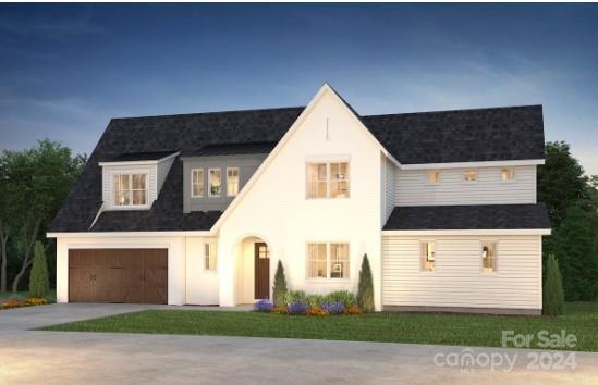 view of front of home with a front yard and a garage